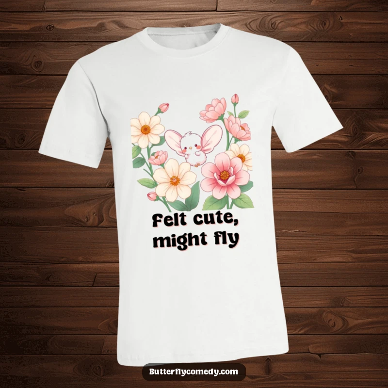 Funny t-shirt with a small, fluffy creature, large rounded wings, joyfully fluttering amidst oversized, vibrant flower blossoms.